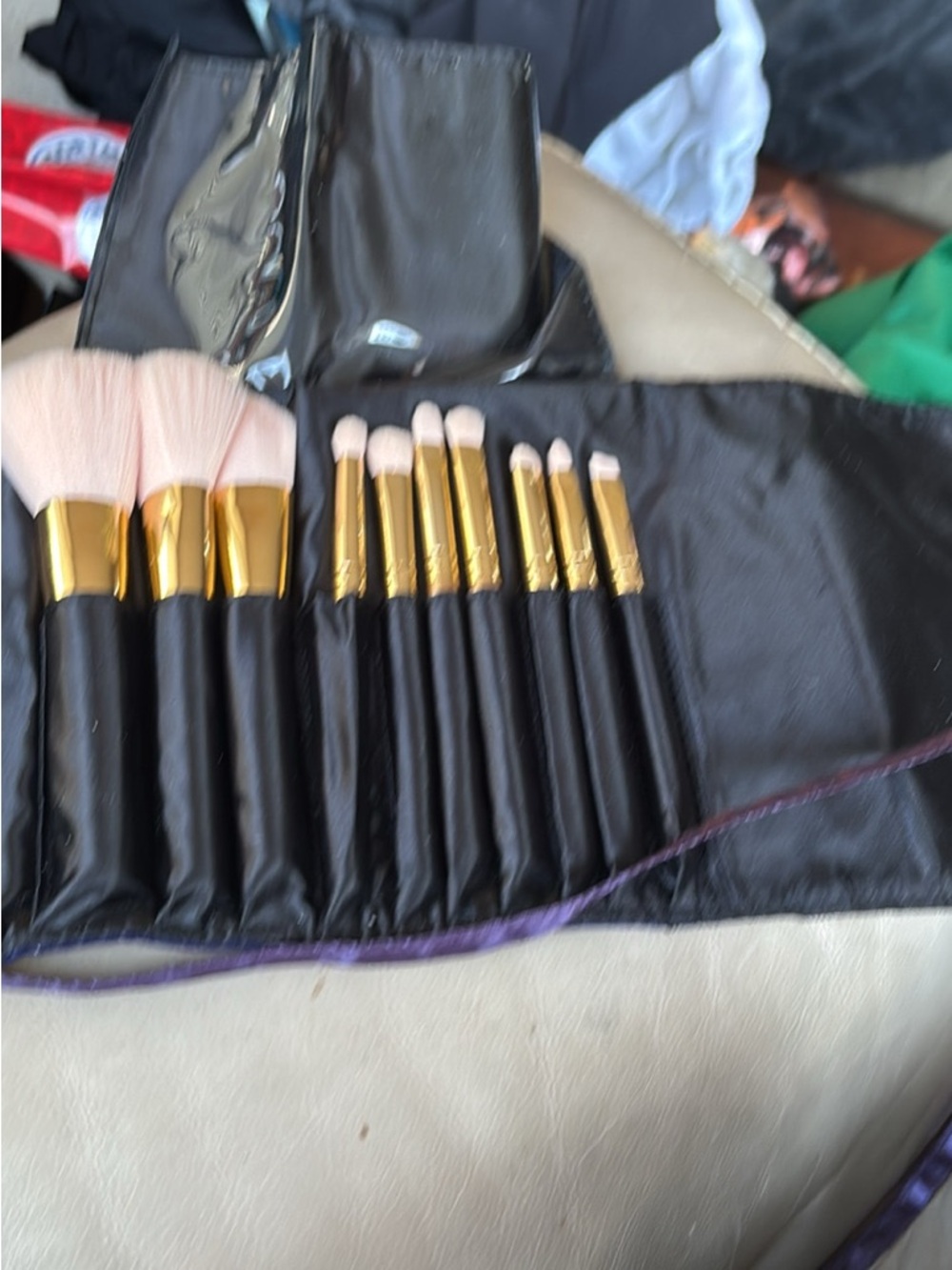 Black and Gold Makeup Brush Set with Pink Bristles and Roll-up. Brand unknown.